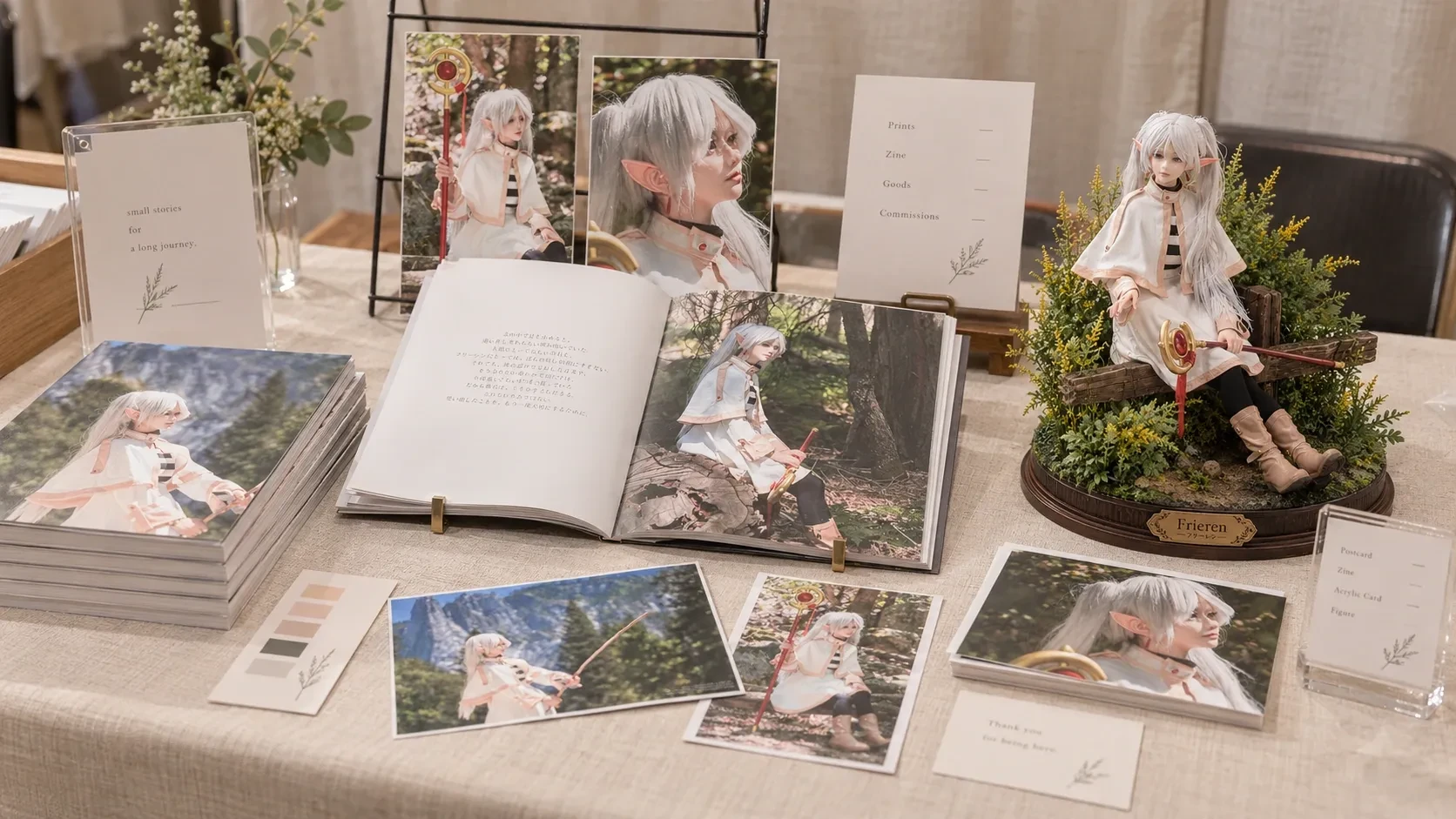 Table display with character photo books, prints, signs and a figure